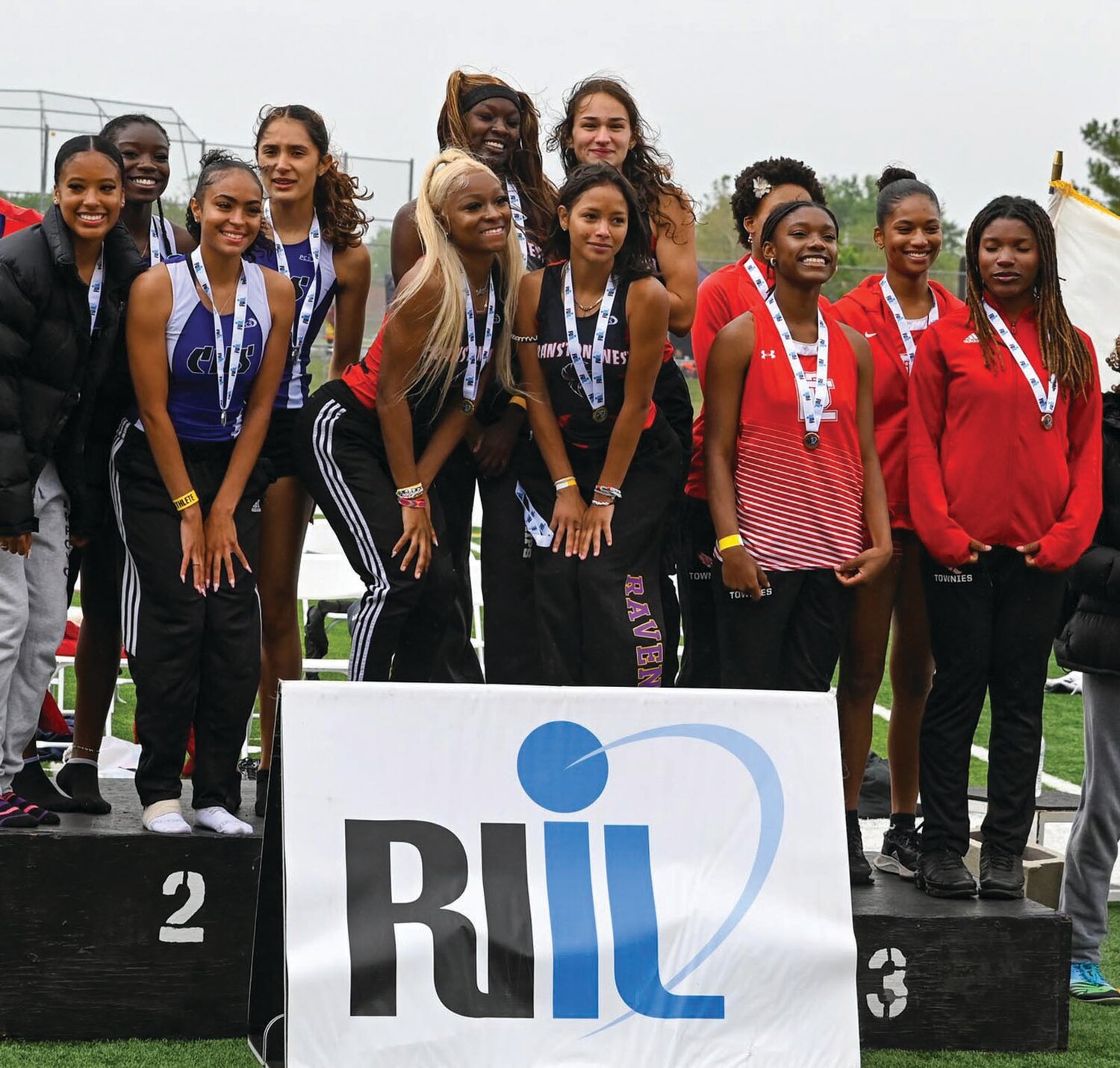 STATE CHAMPS: The Cranston West relay team of Ailani Sutherland, Quiana Pezza, Amelya D’Errico and Praise Mayson on top of the podium after winning the state title in the 400. (Photos by Leo van Dijk/rhodyphoto.zenfolio.com)